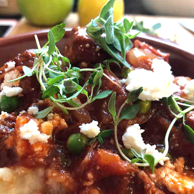 Big outdoor food, huge paella pans, Sussex wedding caterer, event catering, the image shows Chicken & chorizo stew with a feta & pea garnish