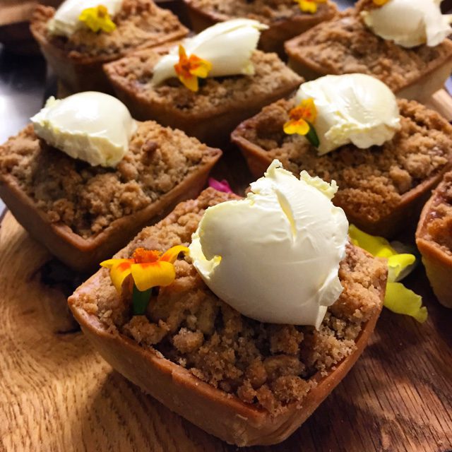 Delicious sweet treats to round of our big outdoor food menus, barbecue in the Sussex countryside catered by The Secret Restaurant for example the image shows our Apple crumble tart with clotted cream & a rum vanilla rice pudding bon-bon