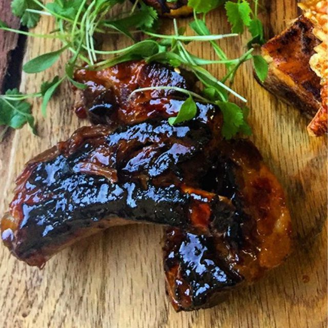 Sussex wedding caterer, event catering perfection. Summer menus to excite you & your guests. The image shows Slow cooked ribs in a maple & whiskey barbecue sauce, glistening & mouth-watering