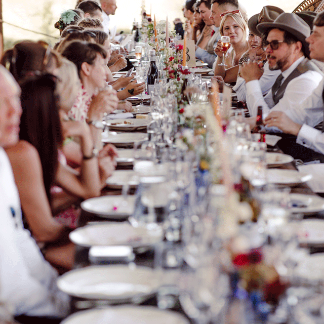 A stylish wedding table, people smiling and talking animatedly... they're having a great time. Quality event catering for weddings, civil ceremonies and parties.