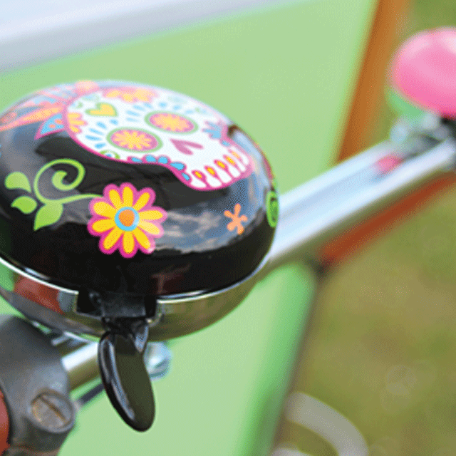 The image shows a close up of the candy skull bell on our pastel coloured gelato trike. Wedding catering Sussex